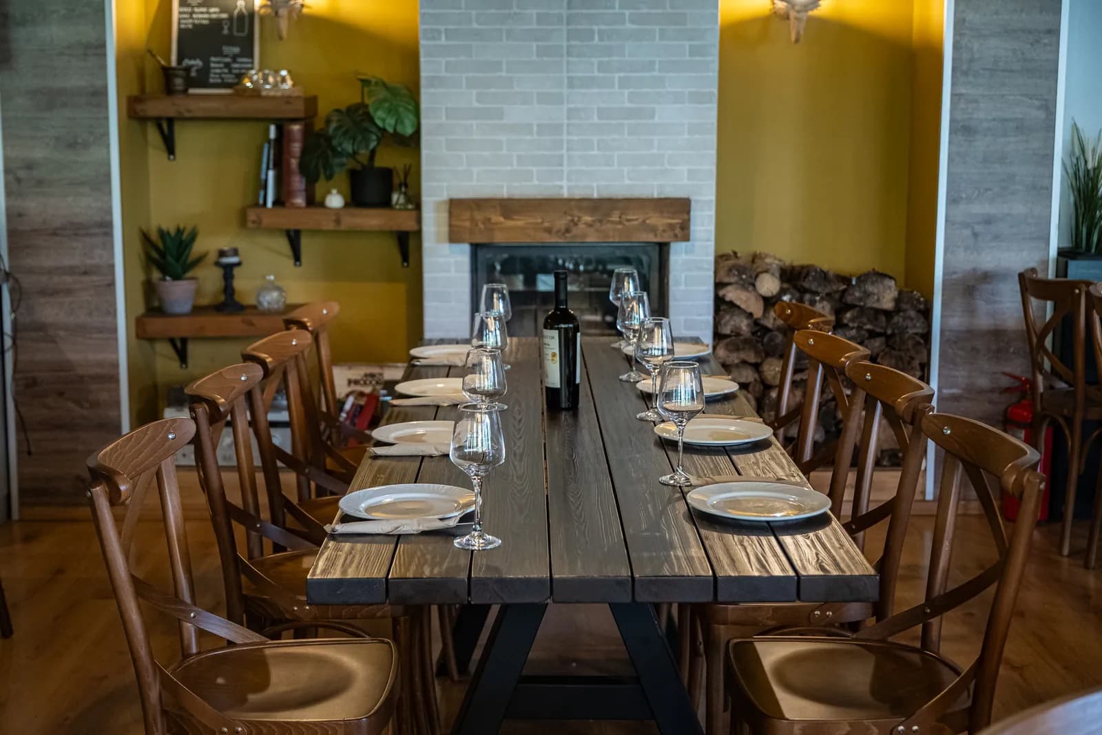 A long table laid for a group in the indoor dining room