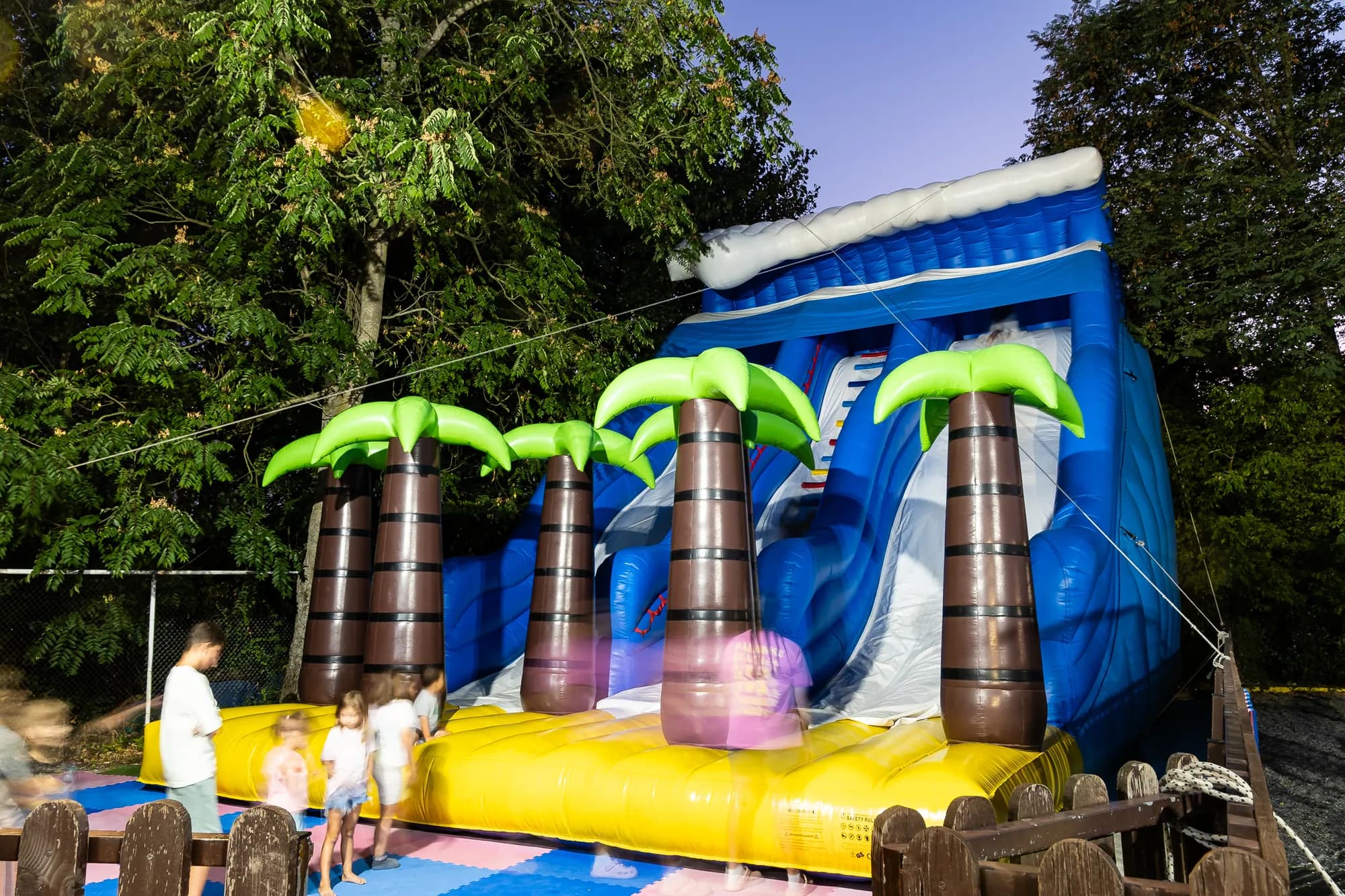 Children playing on the inflatables at the playground